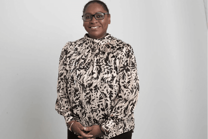 Dawn Dublin standing portrait in a patterned blouse and glasses - ACHFN, African & Caribbean Heritage Food Network
