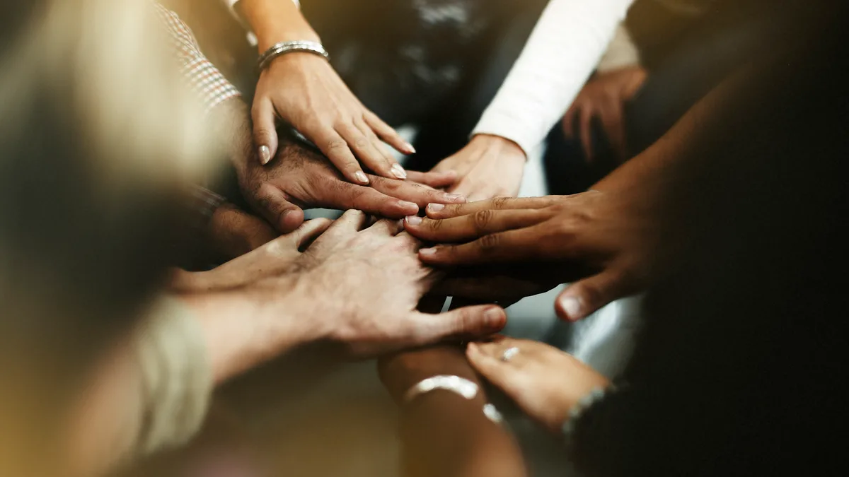 Diverse people joining their hands together - ACHFN, African & Caribbean Heritage Food Network